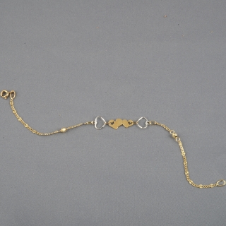 Braccialetto donna realizzato interamente in oro 18kt. Charms Cuori in oro giallo e bianco